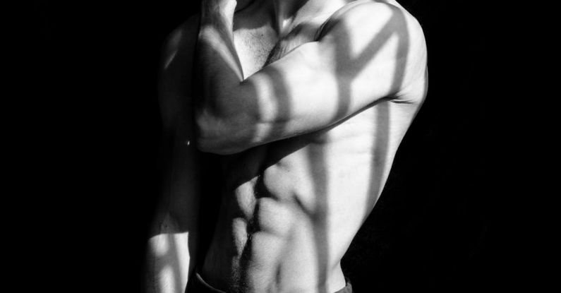 Fitness Goals - A shirtless man with a hat on his head