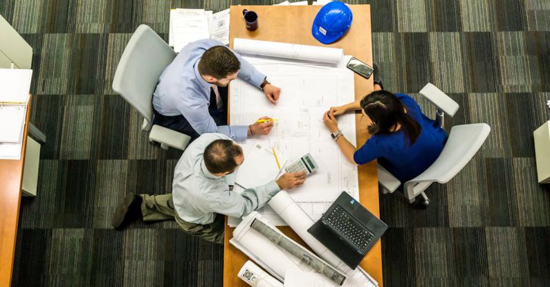 Professional Organization - Three People Sitting Beside Table