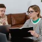 Development Plan - Man and Woman Discussing in Workplace