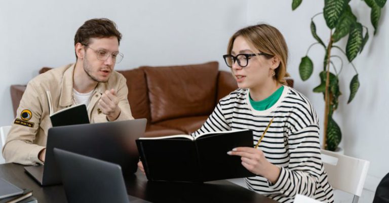 Development Plan - Man and Woman Discussing in Workplace