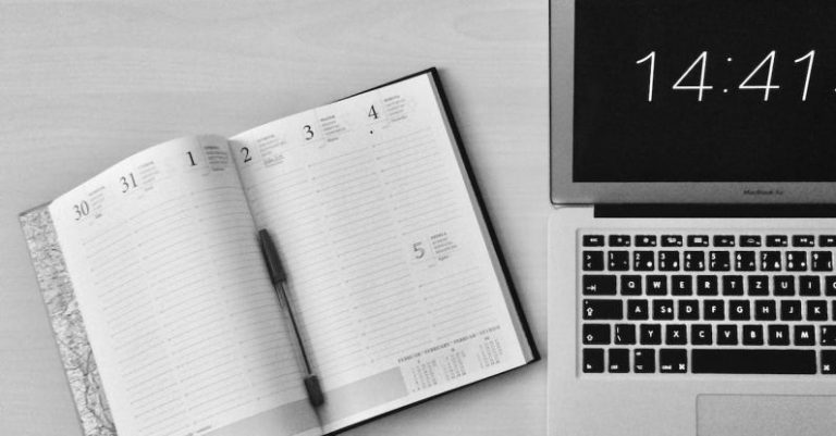 Office Clock - Flat Lay Photography of Unfold Book Beside Macbook