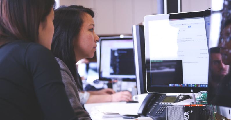 Coaching Development - Two Women Sitting in Front of Computer Monitor