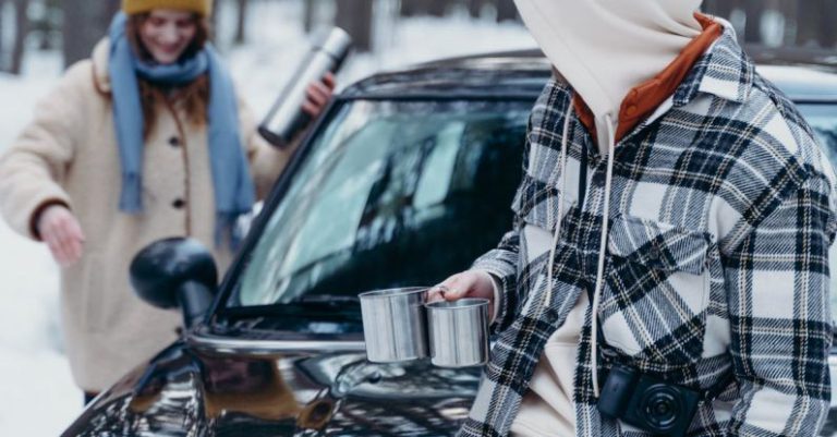 Digital Detox - Couple with Thermos and Metal Mugs in Forest in Winter