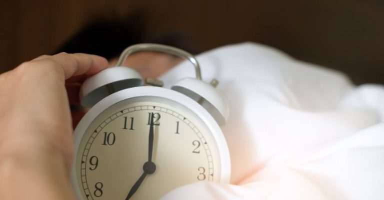Sleep Concept - Photo of Person Holding Alarm Clock