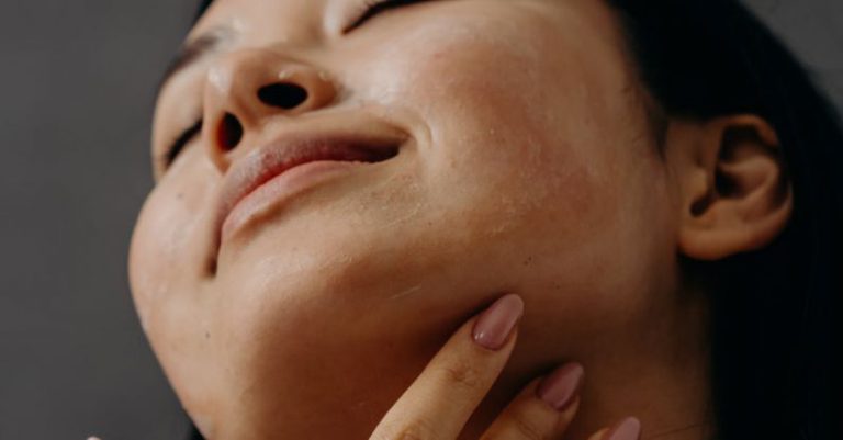 Self-care Routine - A Woman Touching Her Neck with Her Eyes Closed