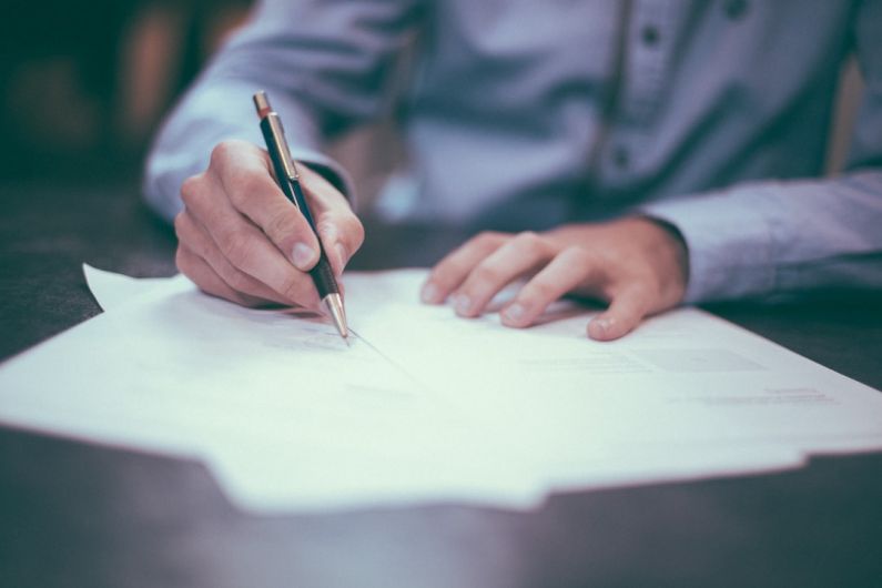 Career - man writing on paper