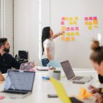 Career - woman placing sticky notes on wall