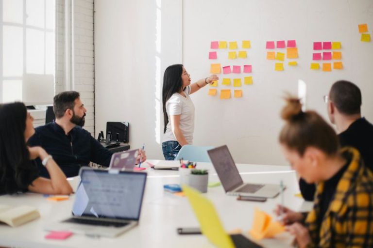 Career - woman placing sticky notes on wall