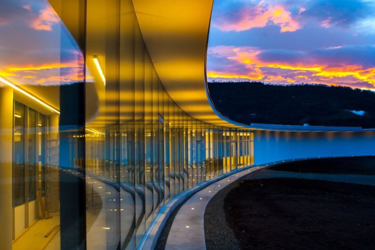 Inovation - clear glass wall building under blue sky with clouds