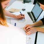 Inovation - woman in black shirt using macbook pro
