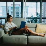 Relax Work - woman in white long sleeve shirt sitting on white couch