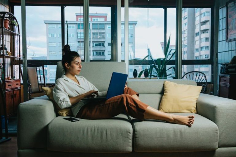 Relax Work - woman in white long sleeve shirt sitting on white couch