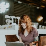 Relax Work - woman sitting on brown wooden chair while using silver laptop computer in room