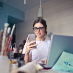Relax Work - woman in white shirt using smartphone