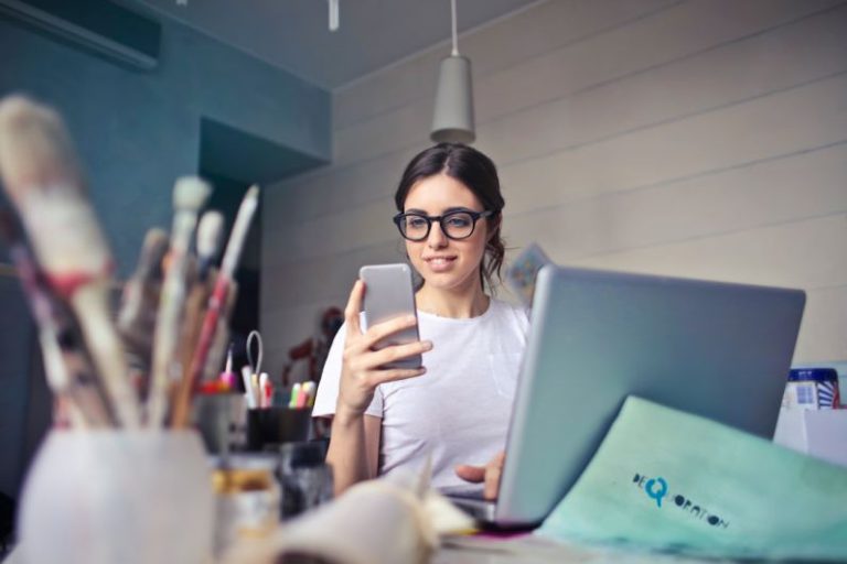 Relax Work - woman in white shirt using smartphone