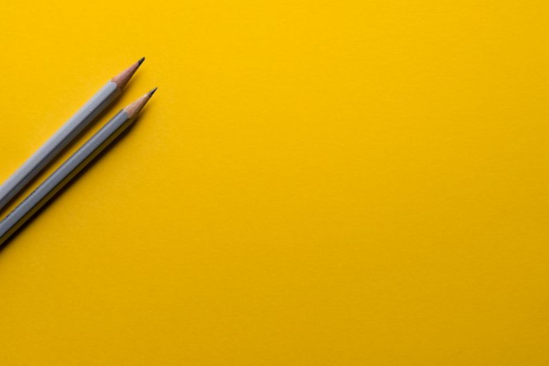 Networking Work - two gray pencils on yellow surface