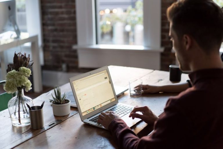 Networking Work - man operating laptop on top of table