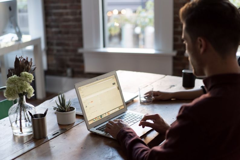 Networking Work - man operating laptop on top of table