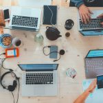 Financial Business - people sitting down near table with assorted laptop computers
