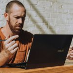 Entrepreneurship - a man sitting at a table using a laptop computer
