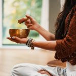 Meditation - woman in brown knit sweater holding brown ceramic cup