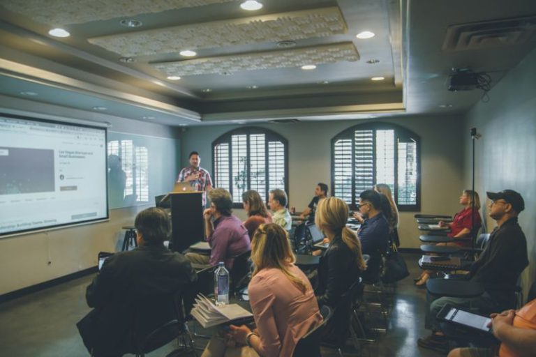 Learning - a group of people in a room with a projector screen