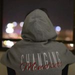 Mindset - person wearing gray and red hooded jacket facing back