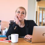 Procrastination - woman in black long sleeve shirt using macbook