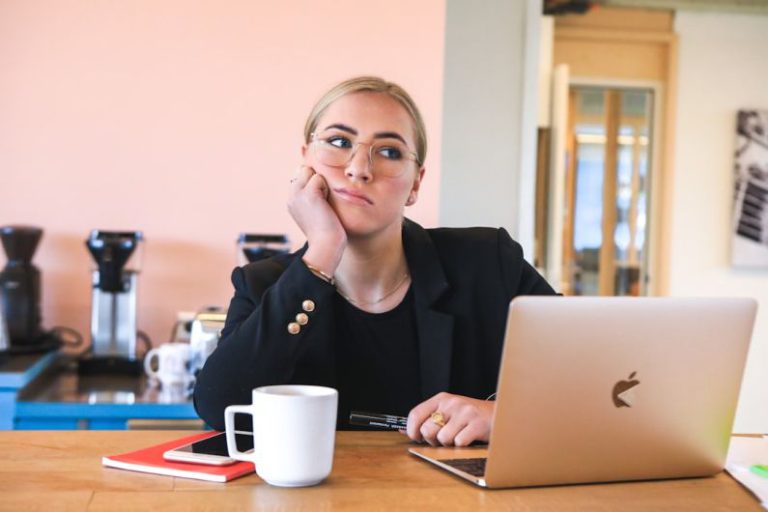 Procrastination - woman in black long sleeve shirt using macbook