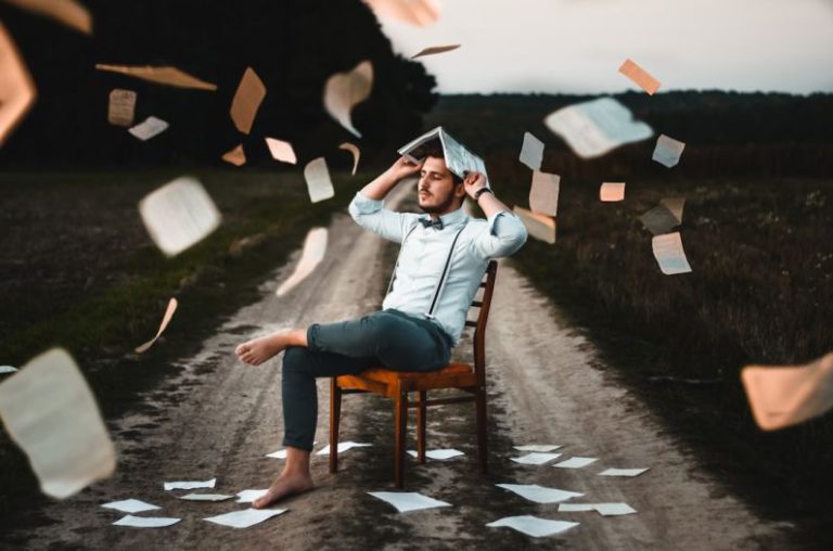 Learning - man sitting on chair with book