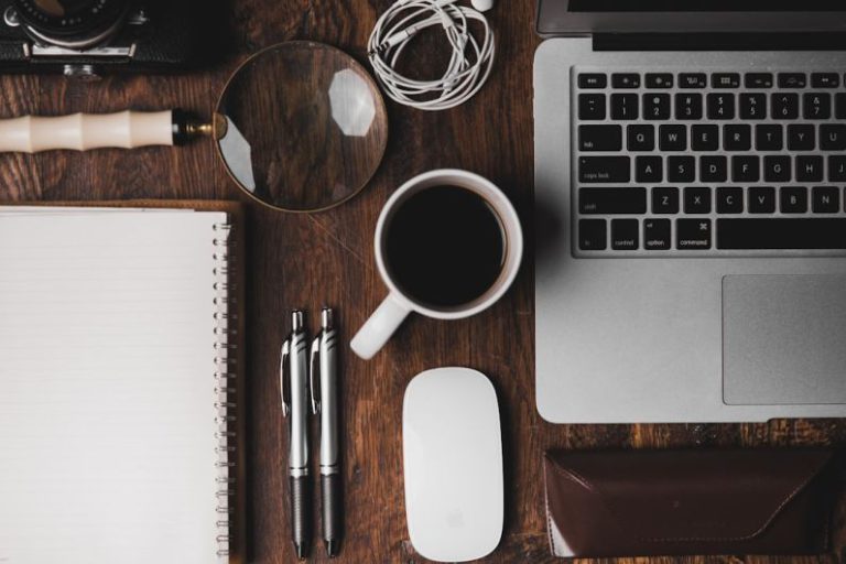 Productivity - cup of coffee near MacBook Pro