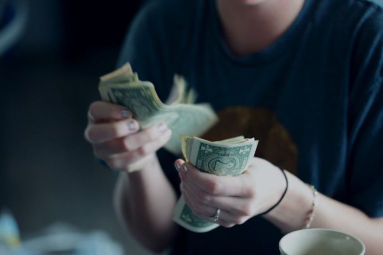 Personal Finance - focus photography of person counting dollar banknotes